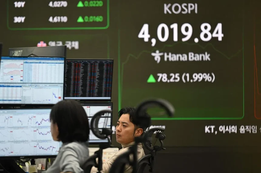 Asia stocks face an AI bubble threat in 2026. Experts monitor high valuations and policy shifts as investors pivot toward regional laggards and defensive assets.