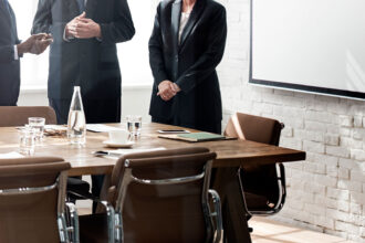 Executives in a boardroom discussing corporate governance and new SEC regulatory compliance standards.