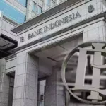 Exterior view of the Bank Indonesia building and logo, representing the institution that manages national interest rates.