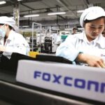 Workers assembling electronic components on a production line at a Foxconn manufacturing facility in Vietnam.