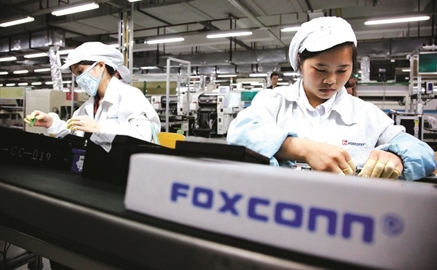 Workers assembling electronic components on a production line at a Foxconn manufacturing facility in Vietnam.