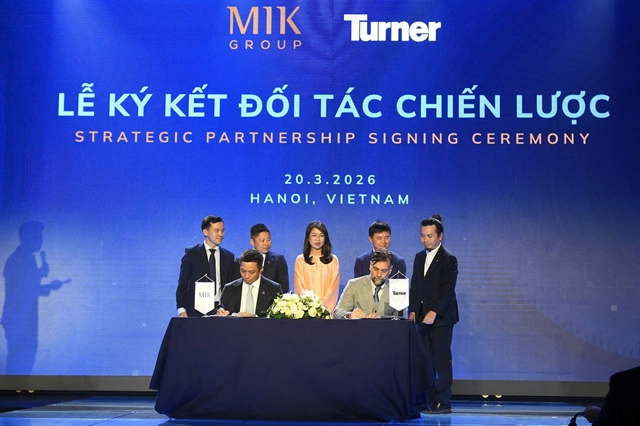 Representatives from MIK Group and Turner signing a strategic partnership agreement during a ceremony in Hanoi.