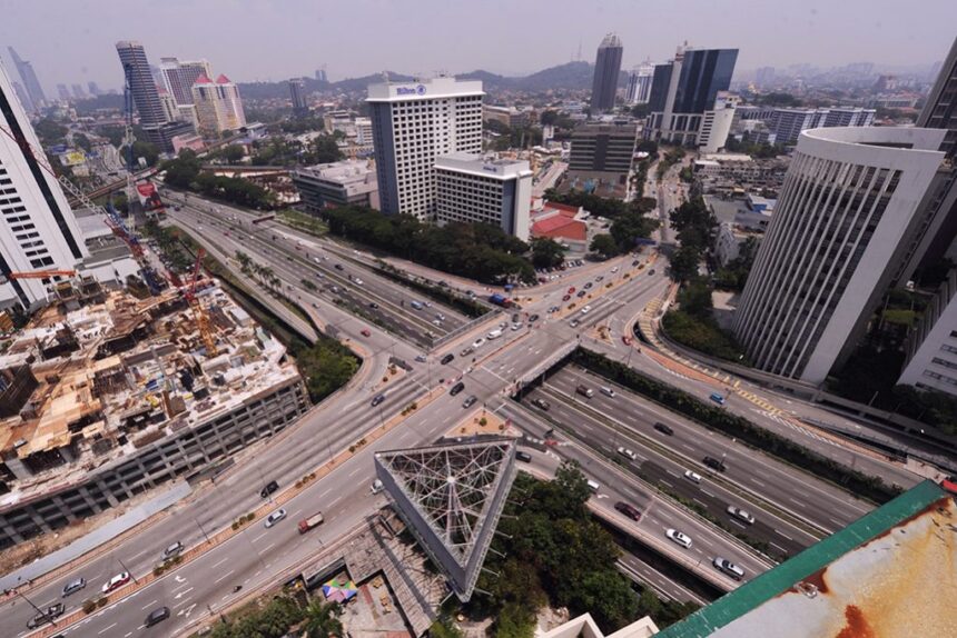 Aerial view of a busy highway intersection in Malaysia, reflecting regional infrastructure amidst low inflation rates.