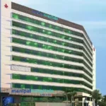 The modern architectural exterior of a Manipal Health hospital building showcasing its clinical infrastructure.