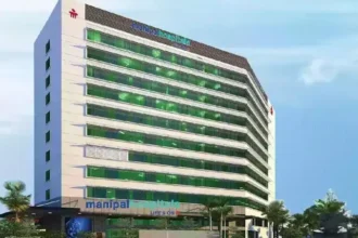 The modern architectural exterior of a Manipal Health hospital building showcasing its clinical infrastructure.