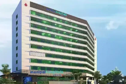 The modern architectural exterior of a Manipal Health hospital building showcasing its clinical infrastructure.