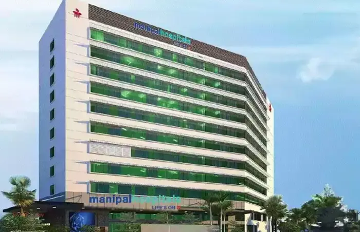 The modern architectural exterior of a Manipal Health hospital building showcasing its clinical infrastructure.
