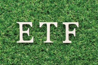 The letters ETF resting on green grass, representing sustainable investment and the MarketVector Vietnam Local Index.