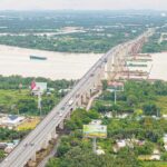 Aerial view of Vietnam's major bridge and infrastructure project supporting national development programmes in a lush region.