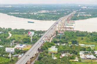 Aerial view of Vietnam's major bridge and infrastructure project supporting national development programmes in a lush region.