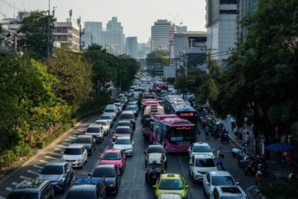 A busy city street in Thailand where economic shifts and foreign fund movements impact national bonds and stability.