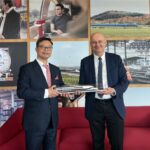 Vietnamese and French officials hold a high-speed railway model during a meeting on transport infrastructure.