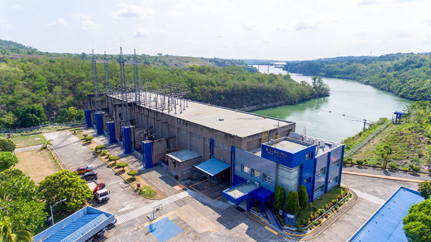 Aerial view of an AboitizPower hydroelectric facility nestled within a lush river landscape in the Philippines.