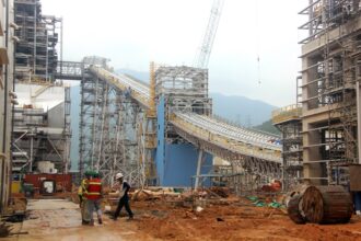 Construction workers monitor the site of a major thermal power project developed by EVN to ensure energy security.