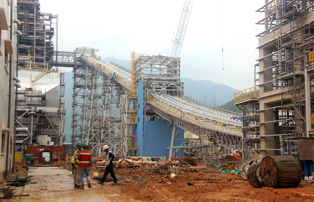 Construction workers monitor the site of a major thermal power project developed by EVN to ensure energy security.