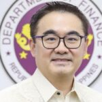 A portrait of Finance Secretary Frederick Go in front of the Department of Finance seal in the Philippines.