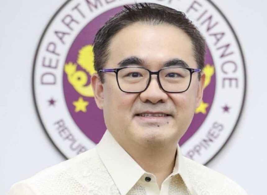 A portrait of Finance Secretary Frederick Go in front of the Department of Finance seal in the Philippines.
