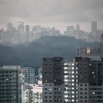 Residential buildings in Singapore under a hazy sky, representing the urban energy demand served by Gasco operations.