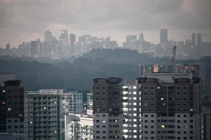 Residential buildings in Singapore under a hazy sky, representing the urban energy demand served by Gasco operations.