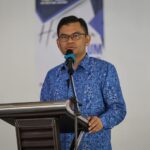 Akmal Nasrullah speaking at a podium, providing government updates on the nationwide B20 biodiesel rollout.