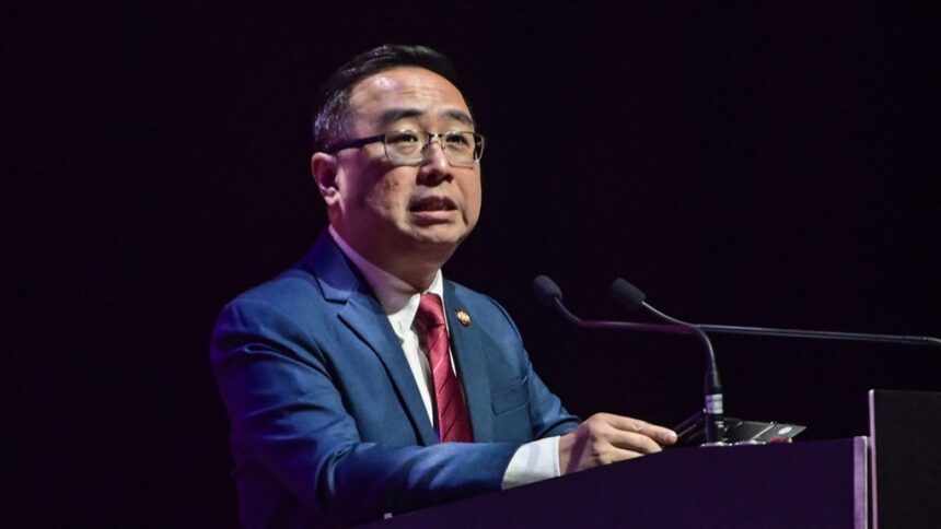 Datuk Chang Lih Kang speaking at a podium during a press conference regarding latest NTIS funding achievements.