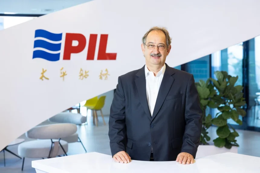 CEO Lars Kastrup of Pacific International Lines standing in front of the company logo at the corporate office.