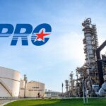 An industrial oil refinery facility featuring storage tanks and processing towers under a clear sky for SPRC.