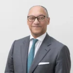 Portrait of Andreas Berger, group CEO of Swiss Re, who provides expert analysis on global economic volatility.