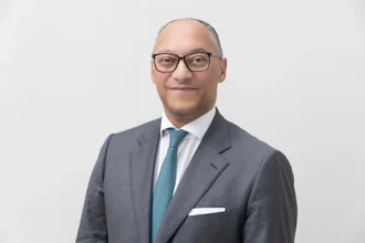 Portrait of Andreas Berger, group CEO of Swiss Re, who provides expert analysis on global economic volatility.