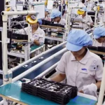Workers in a processing factory assemble electronic components, driving industrial output and the national economy.