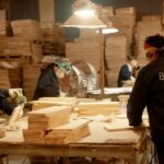 Workers at an assembly line manufacture wood, a key sector for Vietnamese online exporters in global trade.