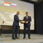 Representatives from Indonesia and Russia exchange gifts during a meeting to strengthen the WGTB framework.