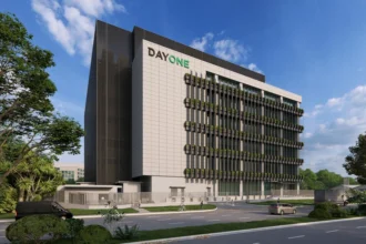 A modern architectural rendering of a multi-story DayOne data centre facility next to an urban road.