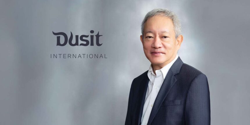 A professional studio portrait of Chanin Donavanik next to the grey Dusit International corporate logo.