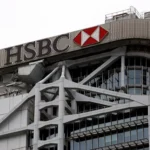 The exterior of a modern skyscraper featuring the prominent logo and signage for HSBC.