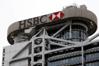 The exterior of a modern skyscraper featuring the prominent logo and signage for HSBC.