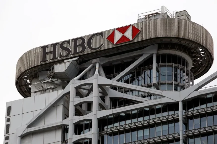 The exterior of a modern skyscraper featuring the prominent logo and signage for HSBC.