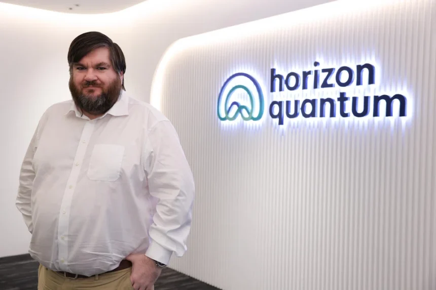 CEO Joe Fitzsimons standing in front of the Horizon Quantum office logo in Singapore.