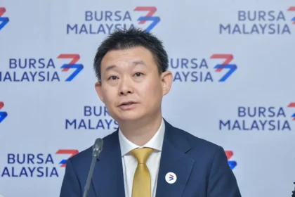 Executive director Wong Chong Siong of Inspace Creation speaking at a press conference in front of a Bursa Malaysia backdrop.