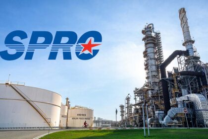 Industrial view of the SPRC oil refinery complex featuring large storage tanks and processing towers under a clear sky.