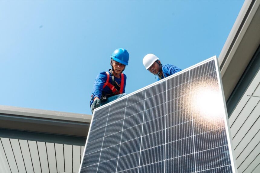 Technicians installing rooftop panels to support Thailand’s new solar financing and clean energy initiatives.