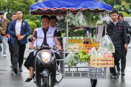 A man drives a motorcycle cart with fresh produce in image_e016d3.jpg, representing Thai consumer confidence drivers.