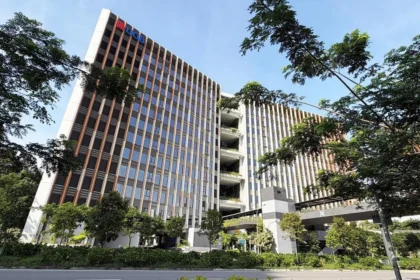 Low angle view of the modern UOB global technology and innovation centre at Tower 80 in Punggol Digital District.