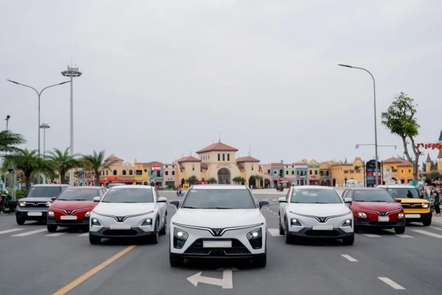 A fleet of VinFast electric vehicles lined up on a city street during a corporate presentation.